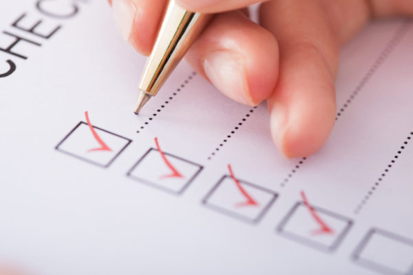 Cropped,Image,Of,Businesswoman,Writing,On,Checklist